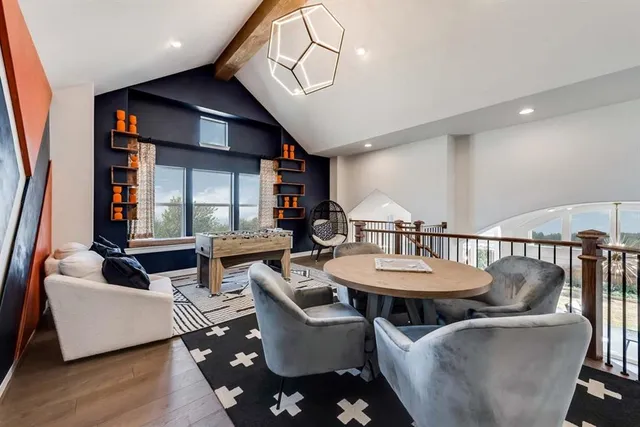 a living room with furniture a wooden floor and a chandelier