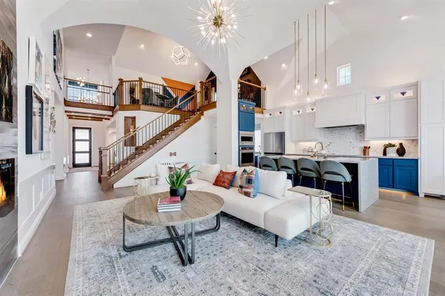 a living room with fireplace furniture and a chandelier