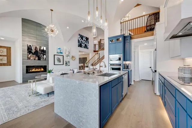 a large kitchen with stainless steel appliances granite countertop a lot of counter space and a sink
