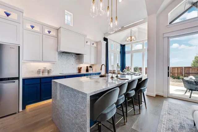 a kitchen with a table chairs sink and cabinets