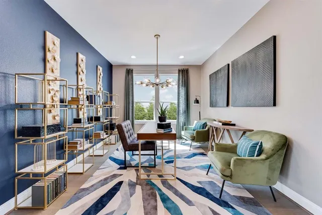 a living room with furniture or chandelier and a wooden floor