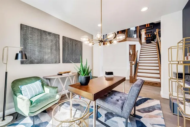 a living room with furniture and a chandelier