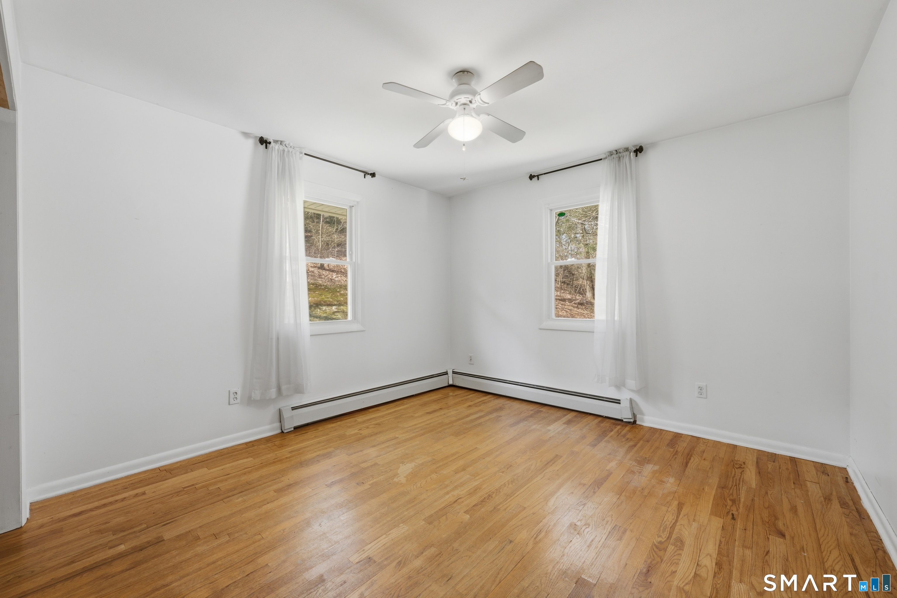 114 Beacon Valley Road Beacon Falls, CT 06403 - Photo 17 of 38 an empty room with wooden floor and windows