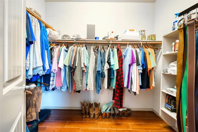 a view of walk in closet with clothes