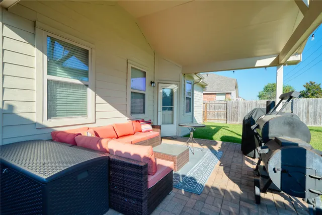 a backyard of a house with yard table and chairs