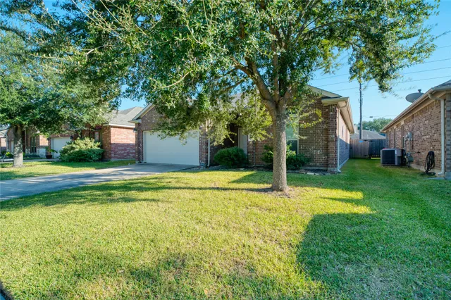 a view of a house with swimming pool and a yard