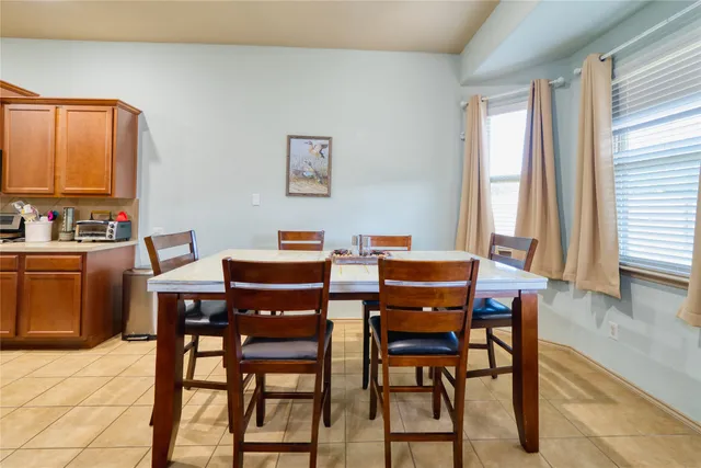 a view of a dining room with furniture and a window
