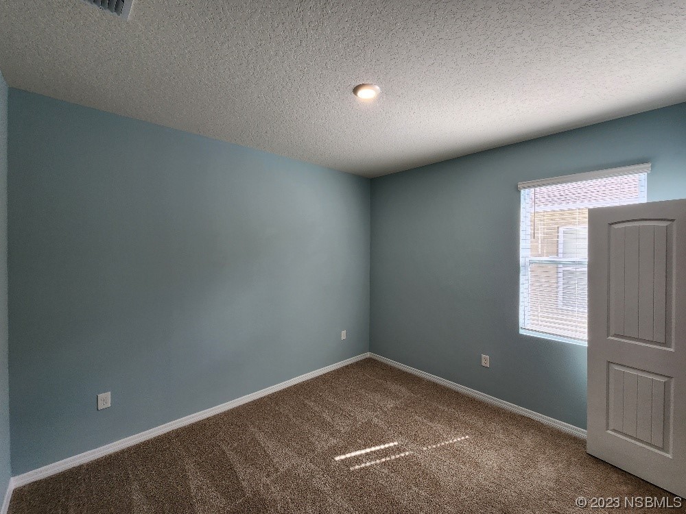 1839 Red Rock Road New Smyrna Beach, FL 32168 - Photo 15 of 23 an empty room with windows