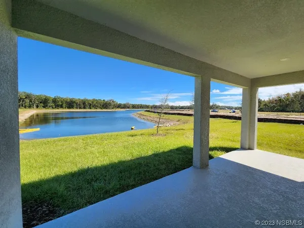 a view of swimming pool and lake in the background