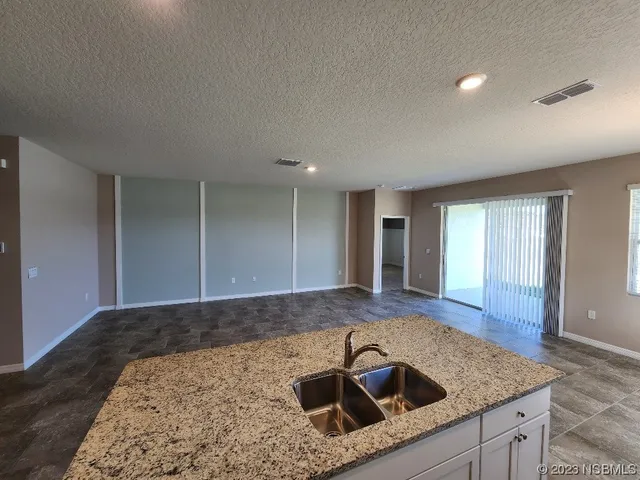 a kitchen with a sink a faucet and window