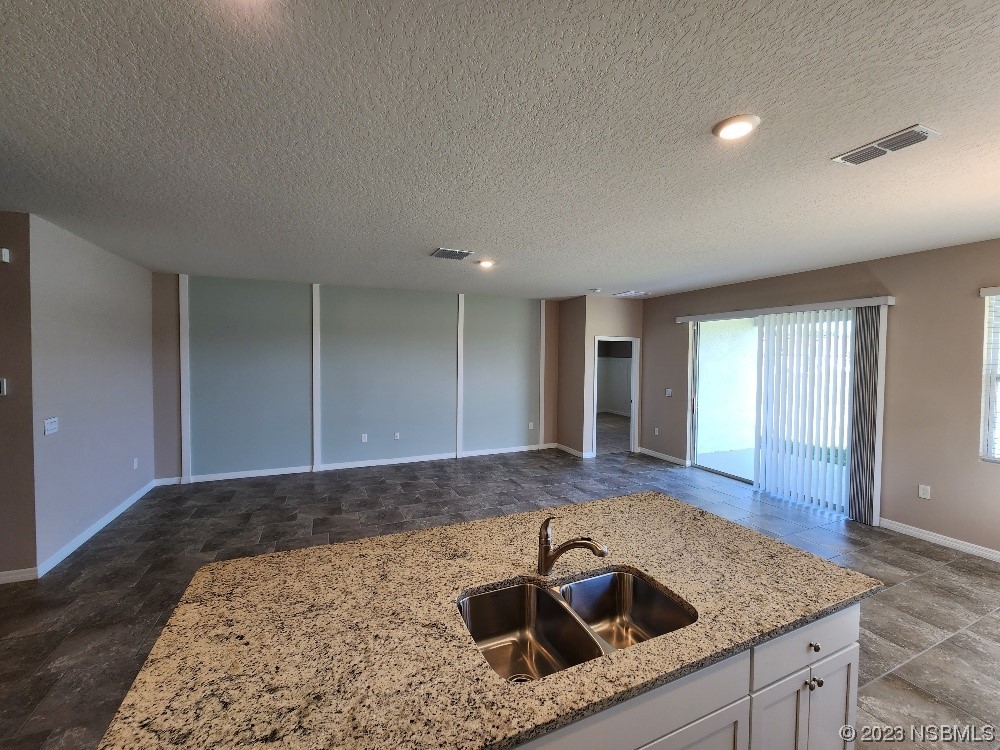 1839 Red Rock Road New Smyrna Beach, FL 32168 - Photo 4 of 23 a kitchen with a sink a faucet and window