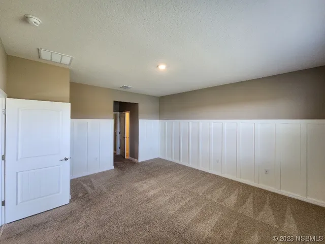 a spacious bathroom with a granite countertop sink and a mirror
