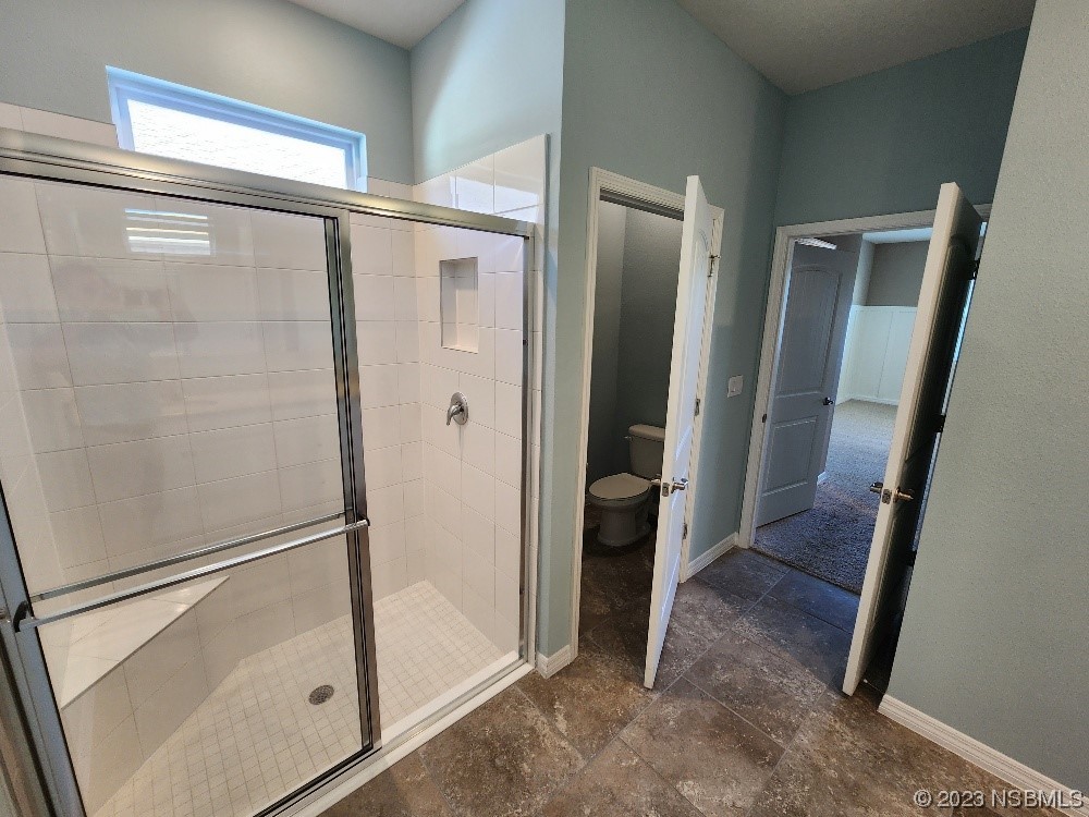 1839 Red Rock Road New Smyrna Beach, FL 32168 - Photo 9 of 23 a bathroom with a glass door shower a sink and a mirror