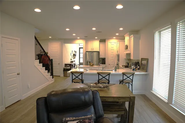 a view of a dining room with furniture and wooden floor