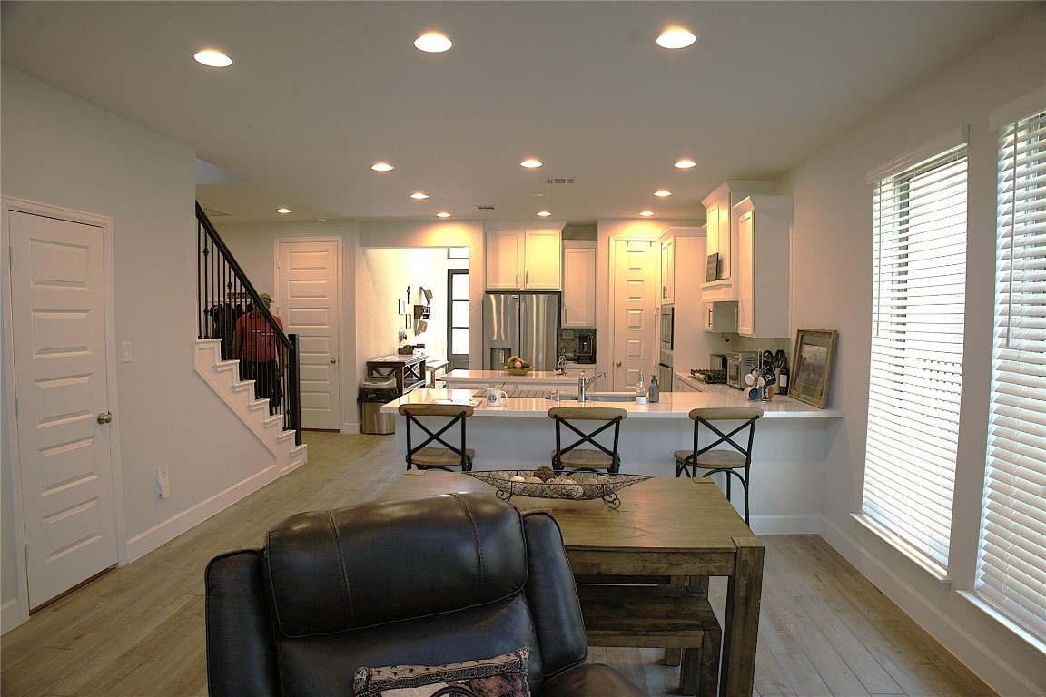 284 Kimble Creek Loop Kyle, TX 78640 - Photo 15 of 32 a view of a dining room with furniture and wooden floor