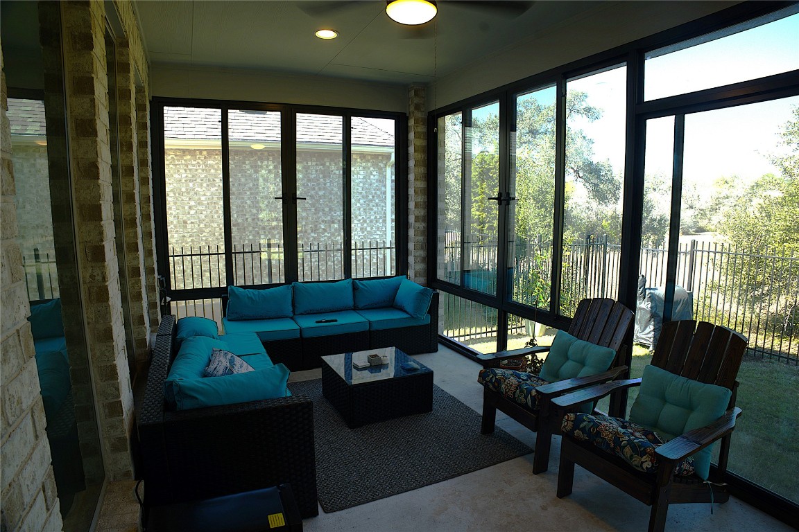 284 Kimble Creek Loop Kyle, TX 78640 - Photo 21 of 32 a living room with furniture and a floor to ceiling window