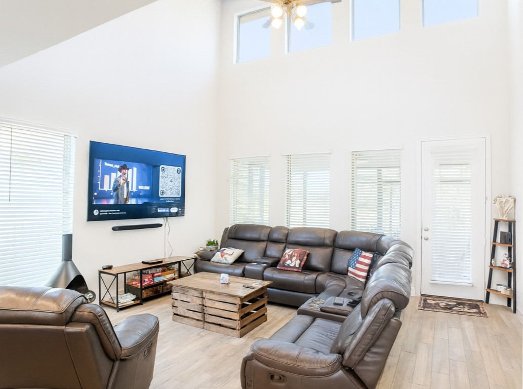 284 Kimble Creek Loop Kyle, TX 78640 - Photo 31 of 32 a living room with furniture a couch and a flat screen tv