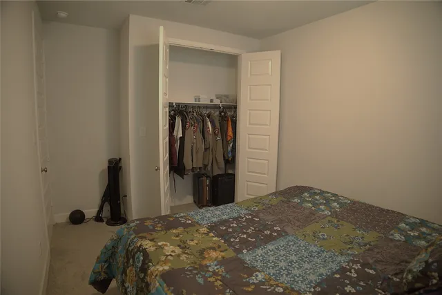 a bedroom with a bed and a closet
