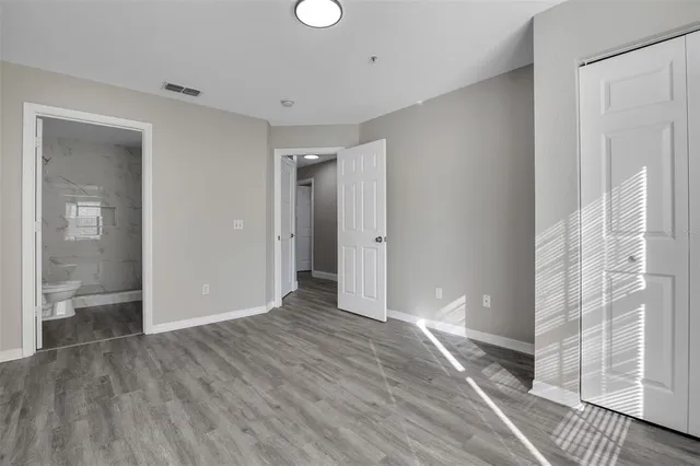 a view of hallway with wooden floor