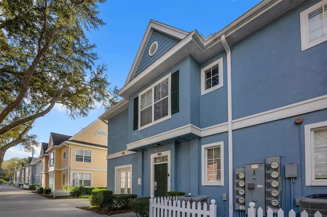 a front view of a residential houses with yard