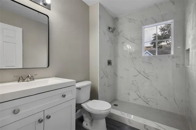 a bathroom with a sink toilet and shower