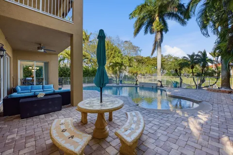 a swimming pool with outdoor seating and yard