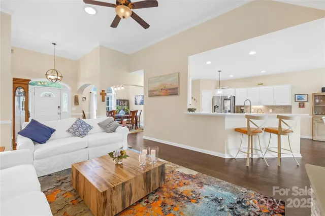 a living room with furniture and kitchen view