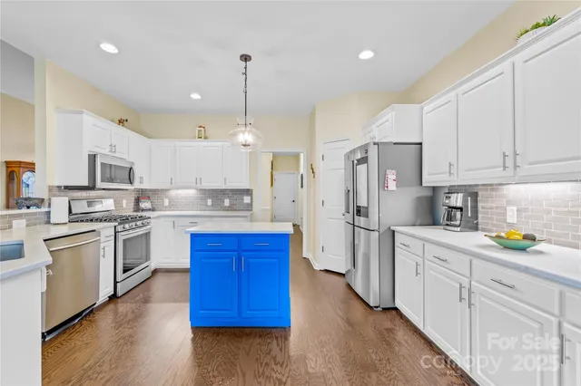 a kitchen with stainless steel appliances and white cabinets