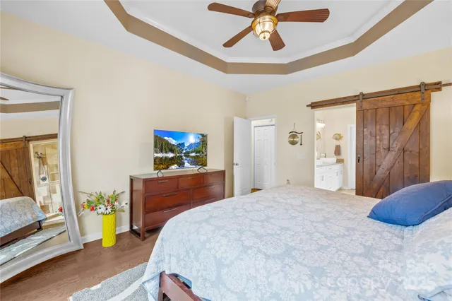 a bedroom with a bed and a chandelier