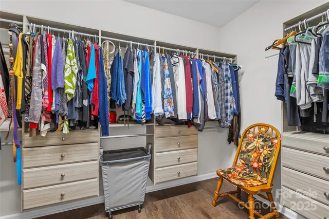 a view of walk in closet with clothes and shoes