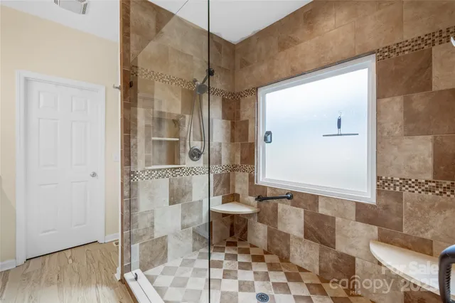 a bathroom with a glass door shower