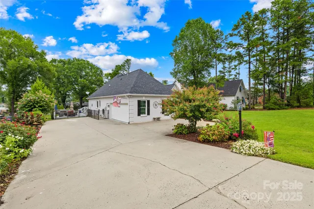 a view of street with brick wall and potted plants