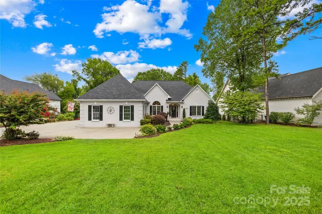 a front view of a house with a garden and yard