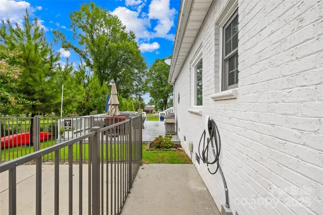 a view of backyard with plants and trees