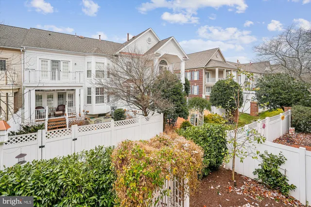 a front view of a house with a yard and tree s