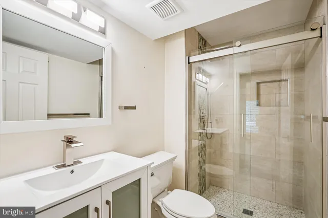 a view of a room with a ceiling fan and a window