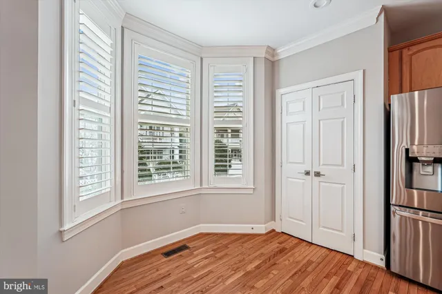 a view of a kitchen with a sink and wooden floor