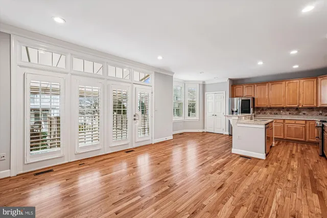 a view of a kitchen with wooden floor and electronic appliances