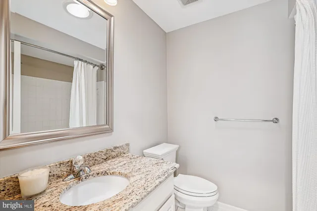 a view of a room with a ceiling fan and a window