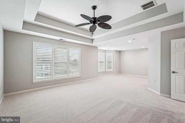 a view of an empty room with a ceiling fan