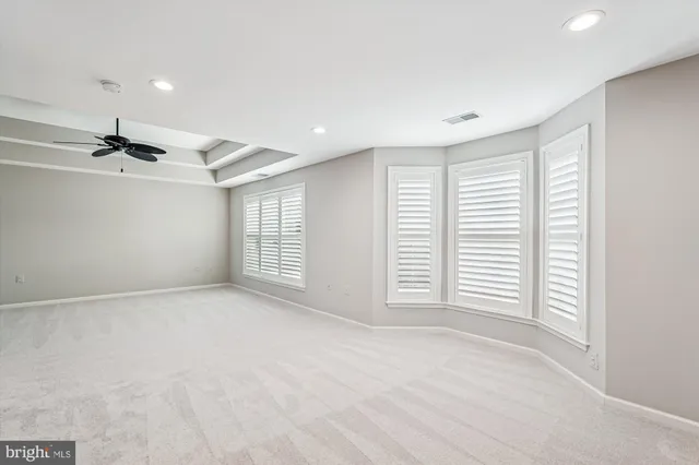 a bathroom with a tub a sink and mirror