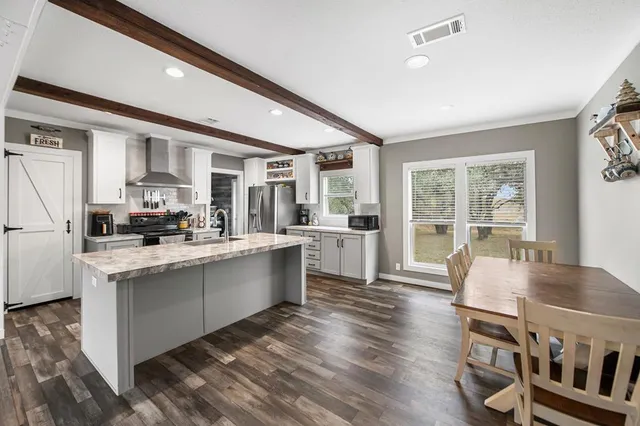 a open kitchen with stainless steel appliances granite countertop a stove and a refrigerator