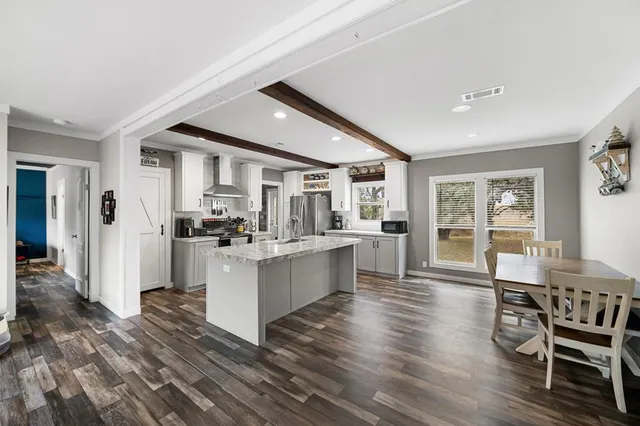 a view of kitchen with sink and wooden floor