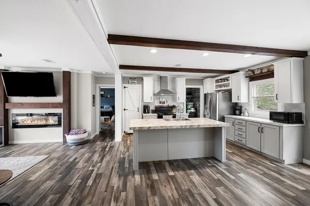 a kitchen with stainless steel appliances granite countertop a stove and cabinets