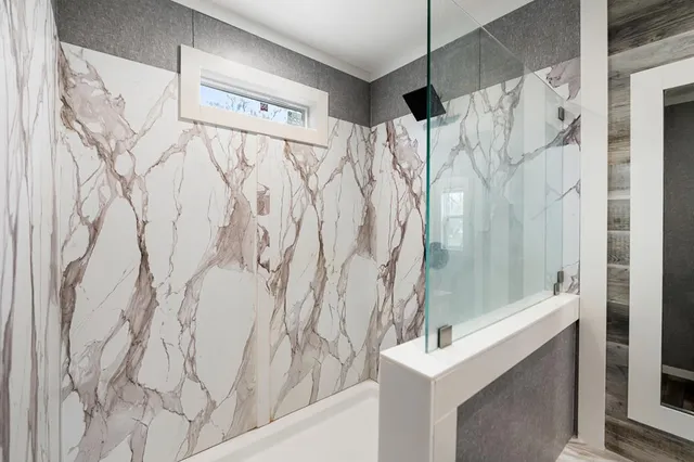 a bathroom with a bathtub and shower