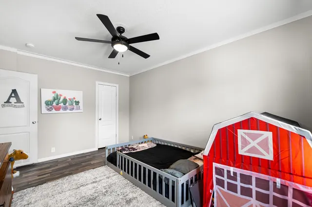 a bedroom with a bed and a chandelier