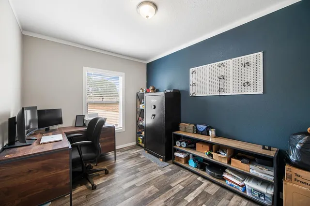 a view of a workspace with furniture and a window