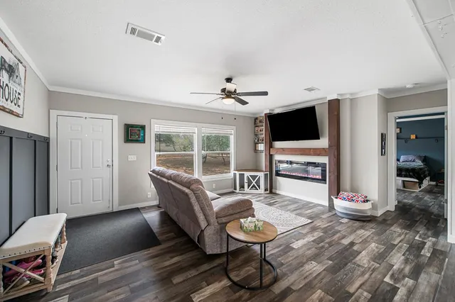 a living room with furniture and a flat screen tv