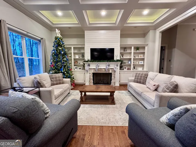 a kitchen with stainless steel appliances a dining table chairs and wooden floor