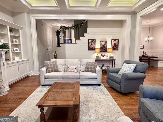 a dining room with furniture and wooden floor